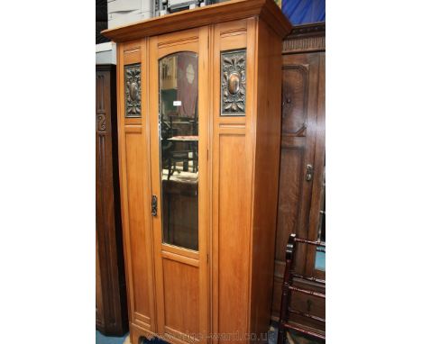 An art nouveau Satinwood single door Wardrobe, moulded cornice (a/f) over single door with arch topped bevelled mirror and lo