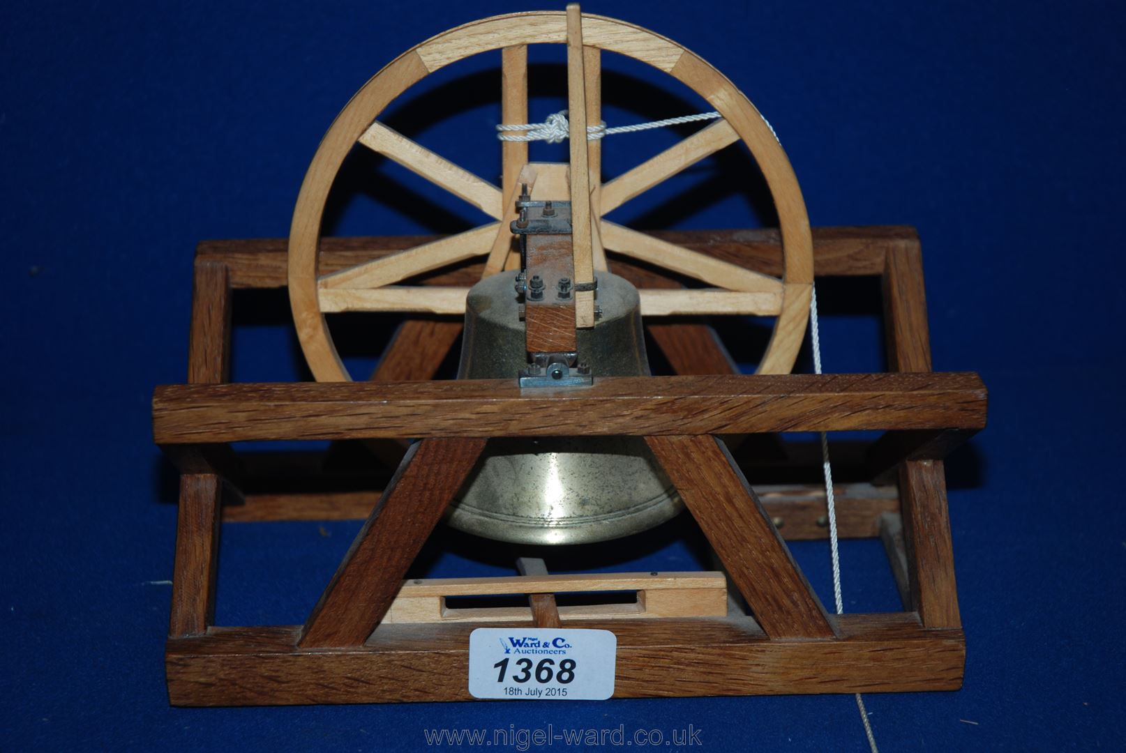 A model of a Church Bell in its mount complete with bell rope.