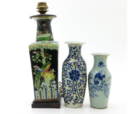 Including a Famille Noir lamp and two blue and white vases, lamp is 47 cm. tall, in diverse conditions.