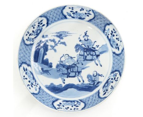 Depicting Chinese hunters on horseback, marked with double ring and conch shell, 23 cm. in diameter, chips on edge.