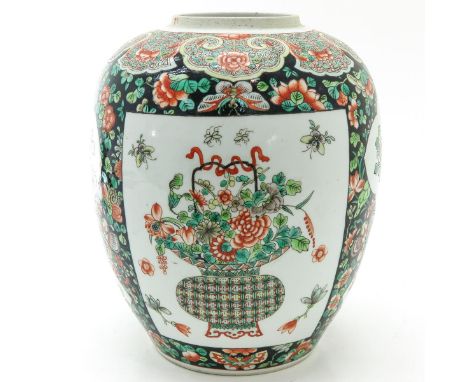 Famille Noir ground with Famille Verte floral enamels, marked with double ring and Artemisia leaf, 31 cm. tall.