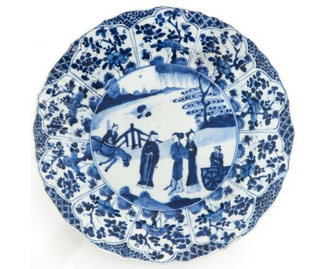 Scalloped edge decorated with florals, center of plate decorated with gathering of Chinese figures, marked with double ring a