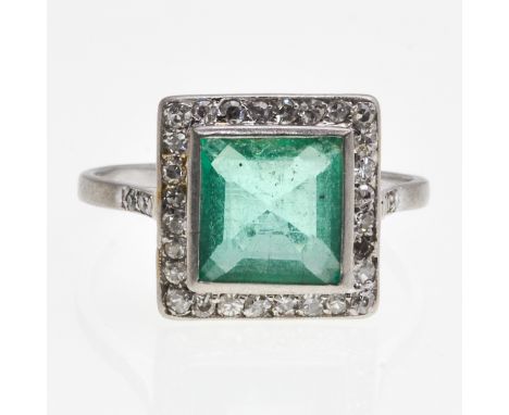 Antique cut diamonds surrounding green stone, ring size 19.