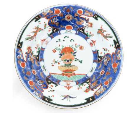 Decorated with florals and phoenix, gilt accents, 28 cm. in diameter, with small chips on edge and stand ring. 