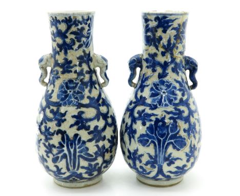 Blue floral decor, marked with double ring, elephant handles, 27 cm. tall, one vase restored.