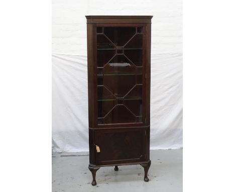 MAHOGANY CORNER CABINETearly 20th century, with glazed astragal door and glass shelf interior, above a single door cupboard b