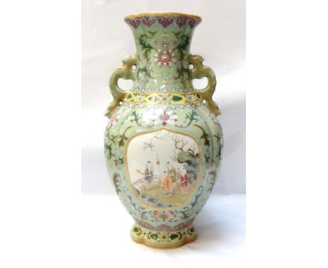 CHINESE CELADON GLAZED PORCELAIN VASEthe vase with twin dragon handles to the flared neck, the body with pictorial panels sur