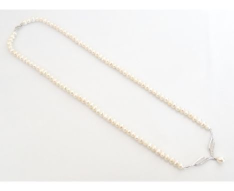 DIAMOND AND CULTURED PEARL NECKLETthe pearl necklace with diamond and pearl set pendant section in nine carat white gold