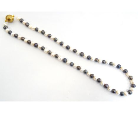 BLACK AND WHITE PEARL NECKLACEwith magnetic ball clasp, approximately 55.5cm long
