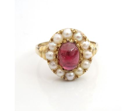 GARNET AND PEARL CLUSTER RINGthe central cabochon garnet in twelve pearl surround, on nine carat gold shank, ring size O