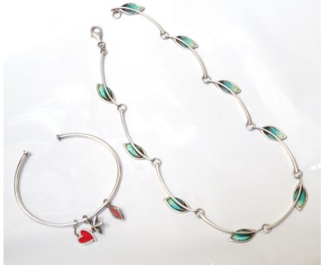 MALCOLM GRAY FOR ORTAK SILVER JEWELLERYcomprising an enamel leaf decorated necklace, and a charm bangle with three various ch