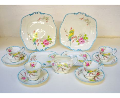 ROYAL PARAGON TEA SERVICEdecorated with Parakeets, roses and daisies, comprising a milk jug, sugar bowl, twelve cups and sauc