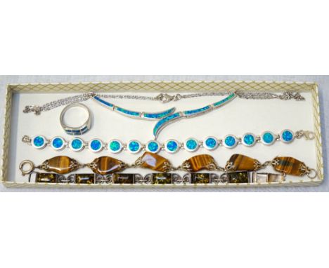 SUITE OF SILVER AND SYNTHETIC OPAL JEWELLERYcomprising a necklace, a bracelet and a ring; together with a tigers eye bead bra