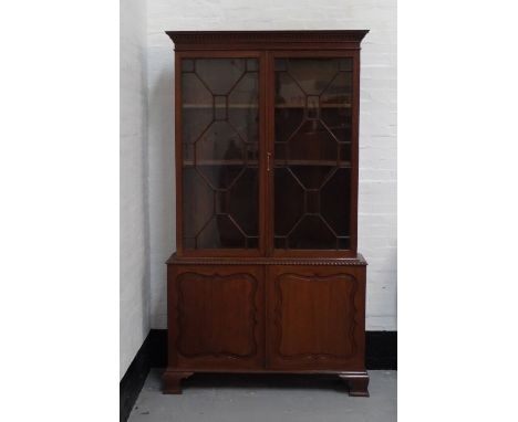 LARGE EDWARDIAN MAHOGANY BOOKCASEthe top with double astragal doors and adjustable shelf interior, above a double door cupboa