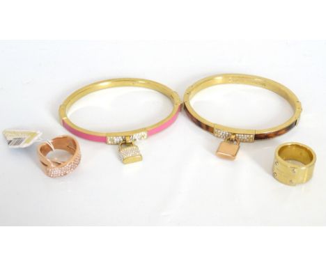 SELECTION OF MICHAEL KORS JEWELLERYcomprising a pink enamel decorated bangle with rhinestone padlock; another padlock bangle 