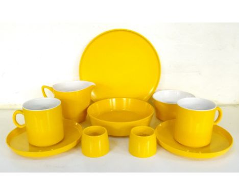 ENCORE MELAMINE PICNIC DINNER SETin yellow and comprising coffee and tea cups and saucers, milk jug, sugar bowl, egg cups and