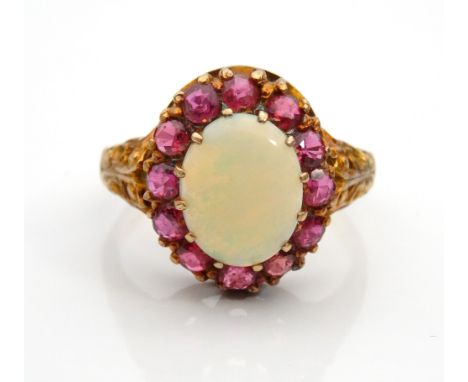 OPAL AND RUBY CLUSTER DRESS RINGthe central oval cabochon opal in twelve ruby surround, on nine carat gold shank, ring size P