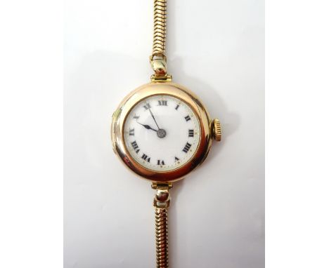1920s LADIES 'ROLEX' NINE CARAT GOLD CASED WRISTWATCHwith black Roman numerals on white enamel dial, 15 jewels, with slim sna