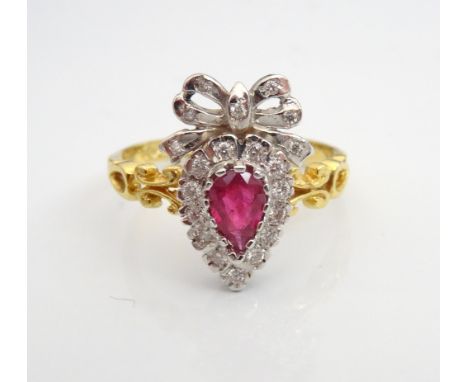 UNUSUAL RUBY AND DIAMOND CLUSTER RINGthe central pear cut ruby approximately 0.4cts in diamond surround and surmounted by dia