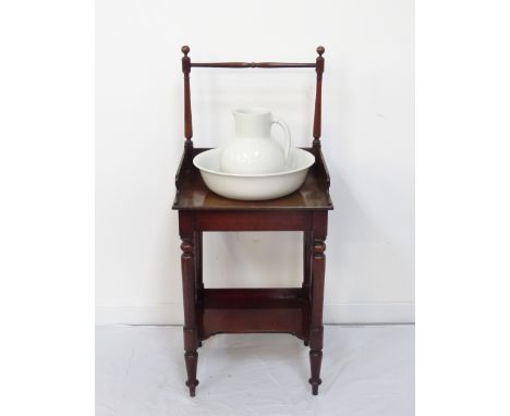 EDWARDIAN MAHOGANY WASHSTANDwith towel rail raised on turned supports, above the gallery washstand tray, with gallery tray un