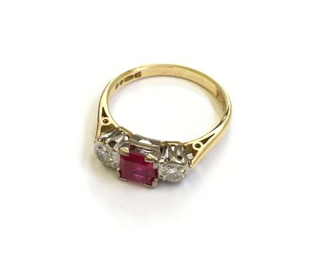 A three stone 18 carat yellow gold ruby and diamond trilogy ring.