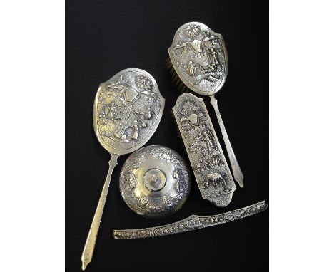 An early 20th century good quality Indian silver dressing table set comprising powder pot, two brushes, hand mirror and comb 