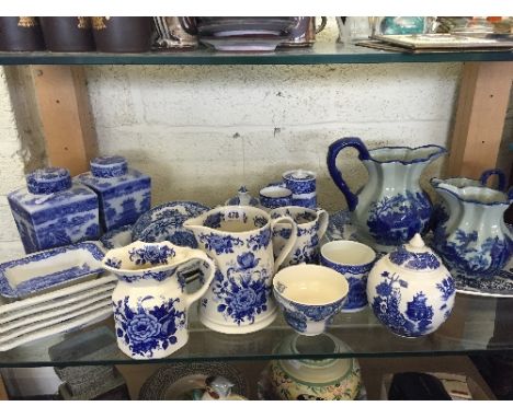 A shelf containing a selection of various blue and white china items.