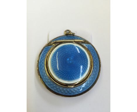 A silver and guilloche blue enamel miniature ladies' compact of circular form.
