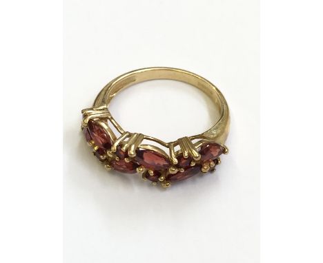 A ladies' 9 carat gold ruby set dress ring (3.3 grams overall).