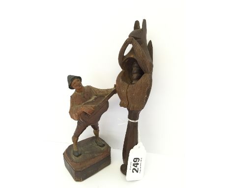 A treen Bavarian style nut cracker modelled as a carved Squirrel together with a carved wooden figure modelled as a Gent Play