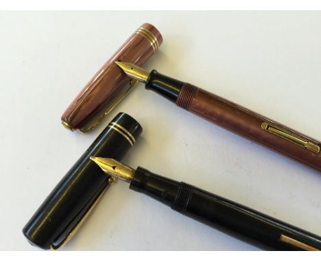 Two vintage fountain pens to include a Waterman lined pink pattern 513 with 14 carat gold nib together with a Mabie Todd Swan