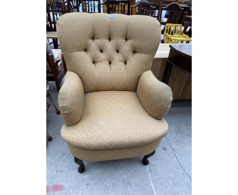 A  MODERN BUTTON-BACK EASY CHAIR ON FRONT CABRIOLE LEGS 