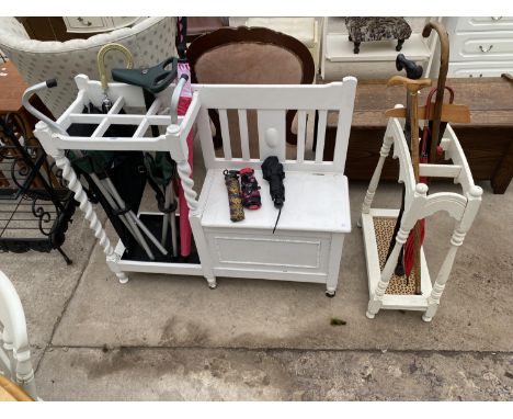 A PAINTED BARLEYTWIST HALL SEAT/STICK STAND, A PAINTED THREE DIVISION STICK STAND AND A QUANTITY OF STICKS AND UMBRELLAS 