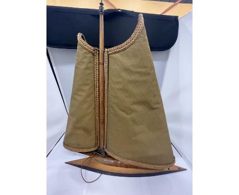A VINTAGE LAMP IN THE SHAPE OF A BOAT WITH FABRIC SHADE AND WOODEN BASE 
