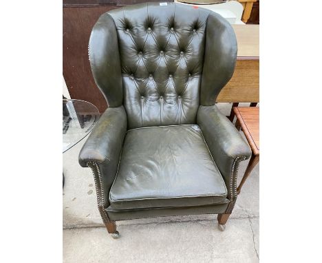 A MODERN FAUX LEATHER BUTTON-BACK WINGED FIRESIDE CHAIR 