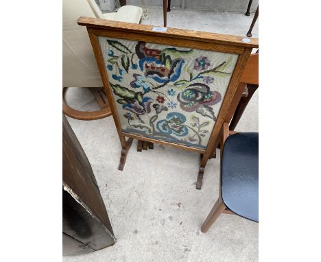 AN EARLY 20TH OAK FIRESCREEN WITH WOOLWORK PANEL 