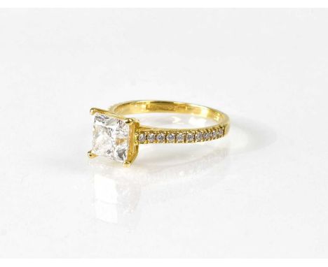 An 18ct yellow gold ring set with a princess cut diamond, approx. 1.7ct, with tiny diamonds to the shoulders, and tiny stone 