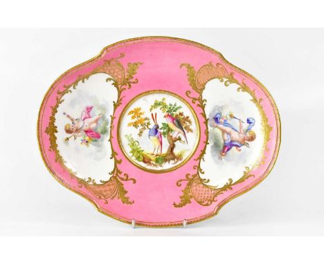 An 18th century Sèvres Vincennes porcelain pink ground dish, painted by Barr, the central roundel painted with a pair of exot