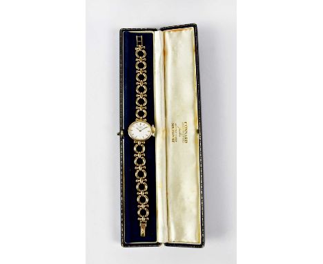 ROTARY; a 9ct gold cased ladies' wristwatch, the white oval dial set with baton numerals, on a 9ct yellow gold strap, diamete