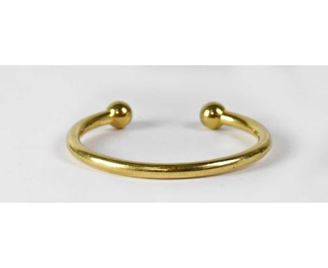 A 9ct gold torque bangle, stamped '375', numbered '1879AR', approx. 68.7g.Condition Report: The internal diameter is 7cm and 