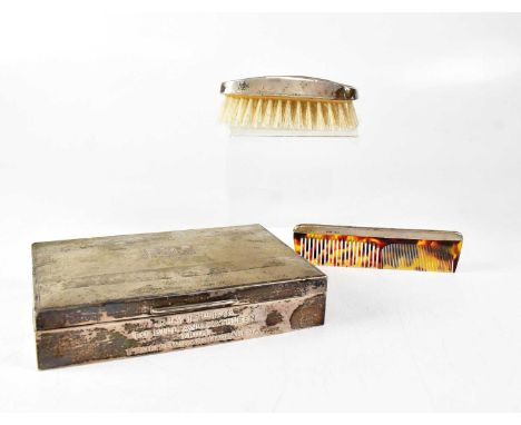 A cased set of silver-backed brush and comb, together with a silver cedar lined rectangular cigarette box, with engine turned