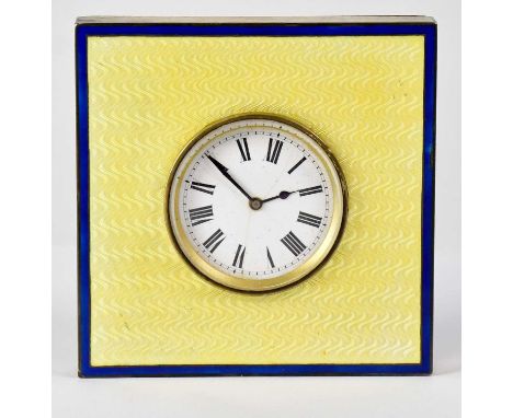 A 1930s mantel clock, the enamelled dial set with Roman numerals within a yellow and blue engine turned mount, on a walnut ea