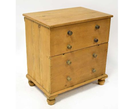 A 19th century rustic small pine commode in the style of a chest of three drawers, raised on bun feet, 68 x 63 x 45cm.