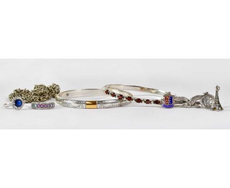 A collection of silver jewellery to include two bangles, two dress rings, a brooch, charms, a chain necklace, etc.Condition R