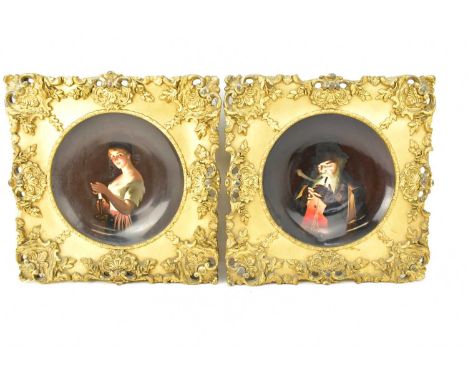 A pair of 19th century Continental hand-painted wall mounting shallow bowls, one painted with a gentleman lighting his pipe, 
