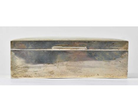 A George VI hallmarked silver cigarette box with engine turned decoration and vacant cartouche, wooden lined, Birmingham 1946