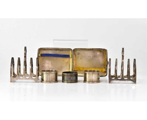 A collection of hallmarked silver items comprising a pair of four-slice toast racks, a pair of napkin rings, a napkin ring an