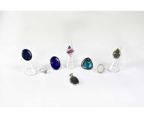 Seven gemstone set rings, comprising examples set with lapis lazuli, moonstone, amethyst and fluorite, all stamped '925', a g
