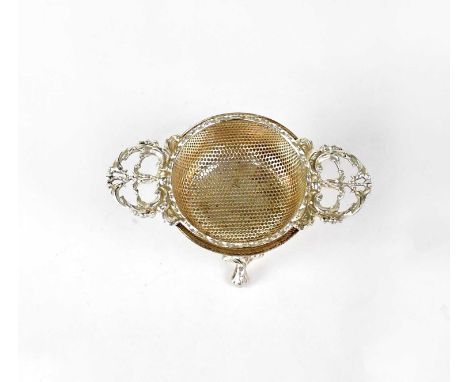 MAPPIN &amp; WEBB; an Elizabeth II hallmarked silver twin-handled tea strainer of circular form, on matching base raised on t