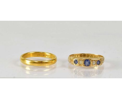 A 22ct yellow gold wedding band, size L, approx. 3.2g, together with an 18ct yellow gold ring set with sapphires and diamonds